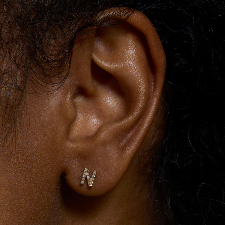 Image of 14K Yellow Gold All Caps Pave Initial Stud on Models Ear