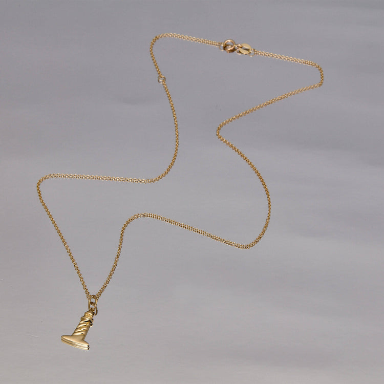 Stone and Strand 10K Yellow Gold Back To Shore Lighthouse Necklace Editorial Image