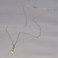 Stone and Strand 10K Yellow Gold Back To Shore Lighthouse Necklace Editorial Image