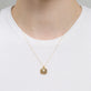 Image of 10K Yellow Gold Beekman Birthstone Locket Necklace on Models Neck