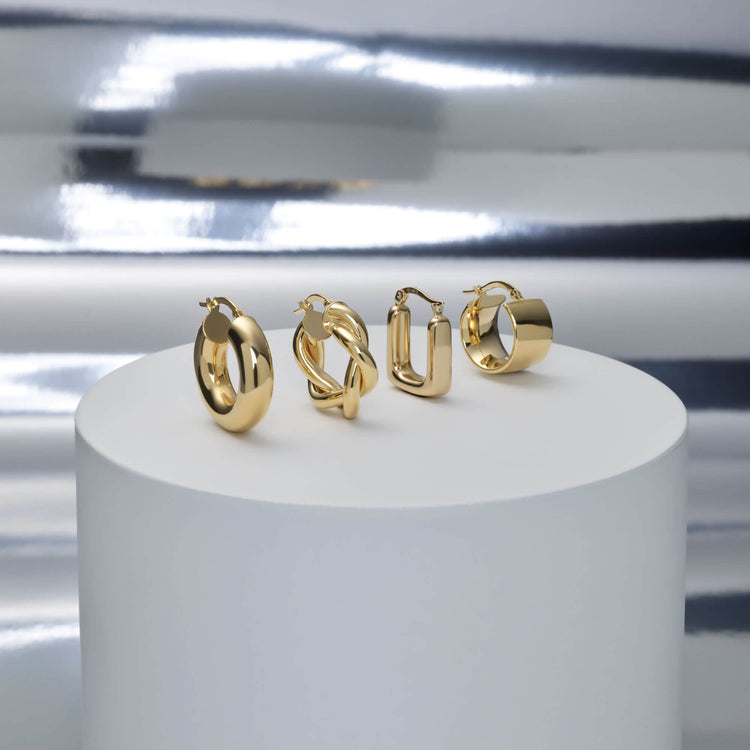 Still life image of Square Second Hole Huggies with Stone and Strand solid gold jewelry