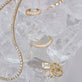 Still life image of Bold Pave Suspemder with Stone and Strand solid gold jewelry