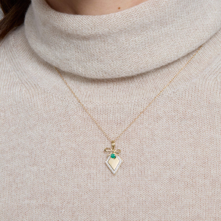 Image of 10K Yellow Gold Bow Nouveau Diamond Tag Necklace with Emerald on Models Neck