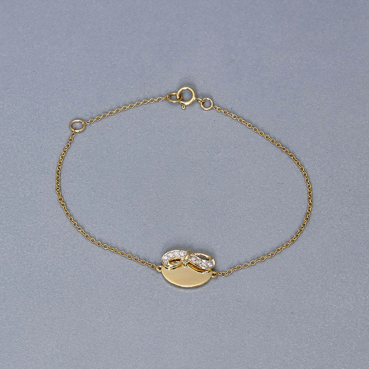 Stone and Strand 10K Yellow Gold Bow Nouveau Diamond ID Bracelet Editorial Image