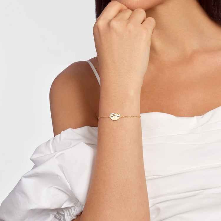 Image of 10K Yellow Gold Bow Nouveau Diamond ID Bracelet on Models Arm