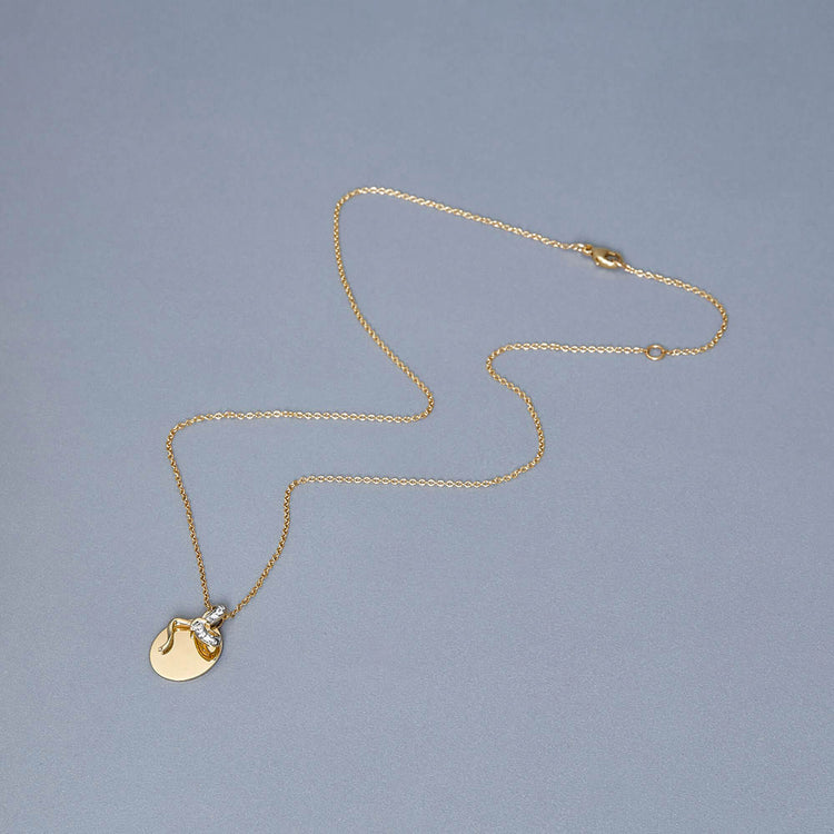 Stone and Strand 10K Yellow Gold Bow Nouveau Diamond Medallion Necklace Editorial Image