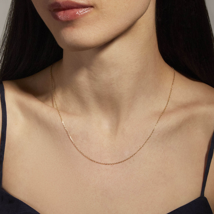 Image of 14K Yellow Gold Pivot by Stone and Strand 4-Way DC Cable Chain on Models Neck