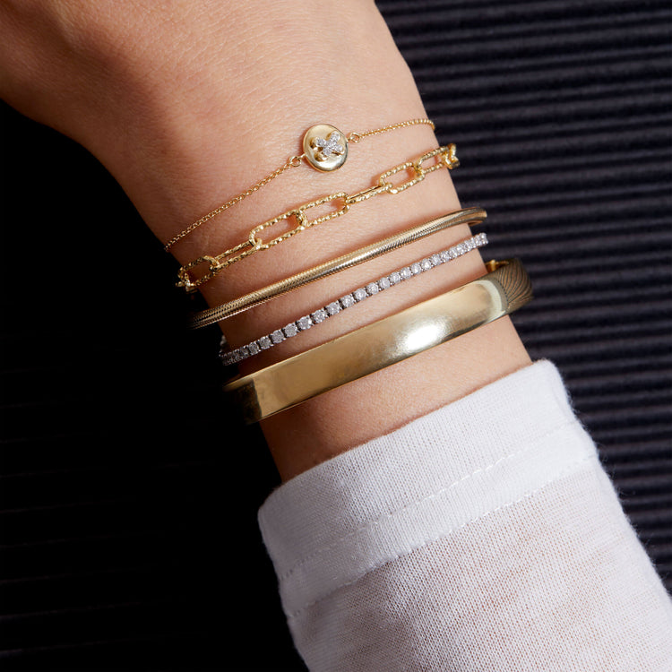 Model wearing Gold Cigar Bangle with solid gold Stone and Strand jewelry