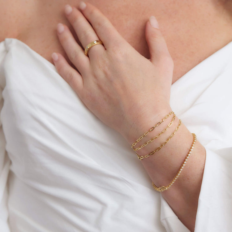 Model wearing Drop Shot Diamond Tennis Bracelet with solid gold Stone and Strand jewelry