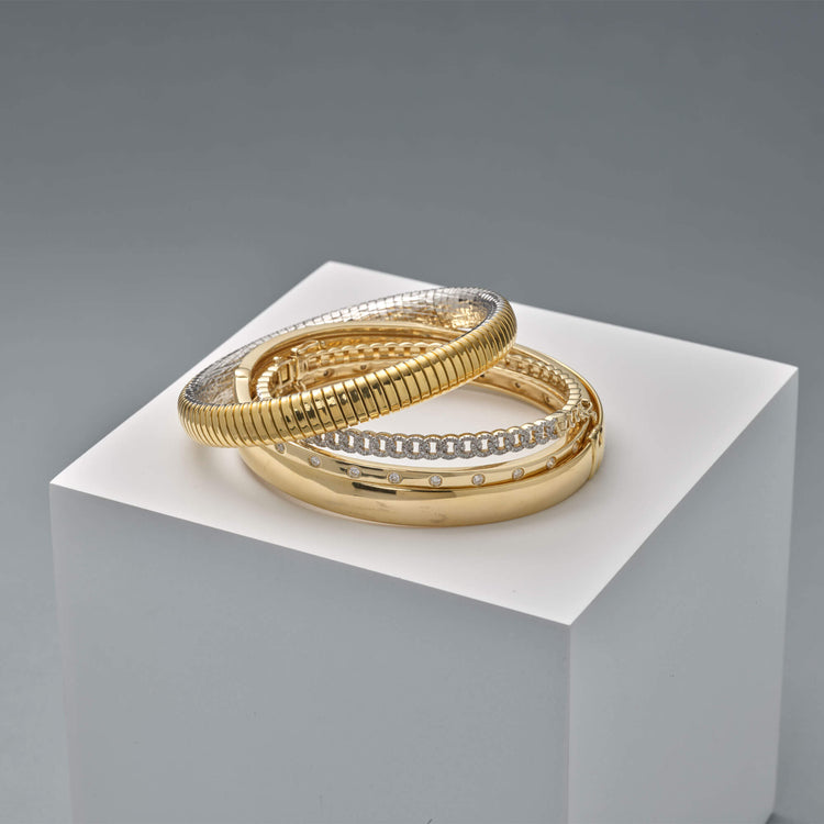 Still life image of Gold Cigar Bangle with Stone and Strand solid gold jewelry