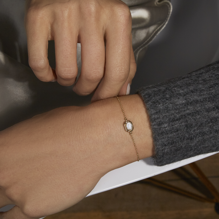 Image of 14K Yellow Gold Birthstone Emerald Cut Bonbon Bracelet with White Topaz on Models Arm