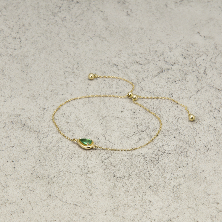 Stone and Strand 14K Yellow Gold Birthstone Pear Cut Bonbon Bracelet with Emerald Editorial Image