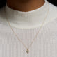Image of 10K Yellow Gold Candy Aqua Charm with Aquamarine on Models Neck