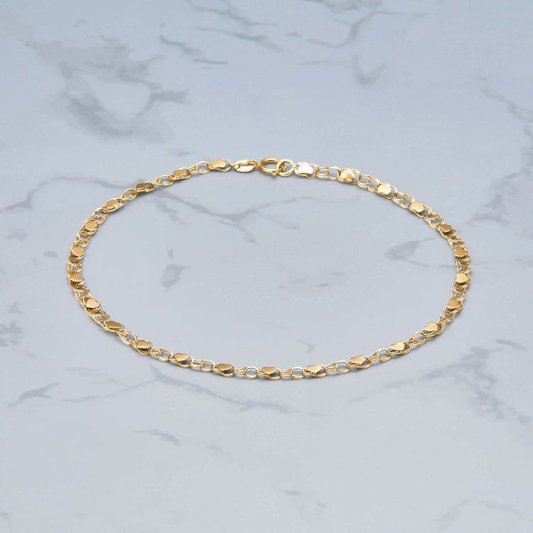 Stone and Strand 10K Yellow Gold Chained to My Heart Anklet Editorial Image