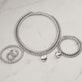 Still life image of In A Twist Silver Bangle with Stone and Strand silver jewelry