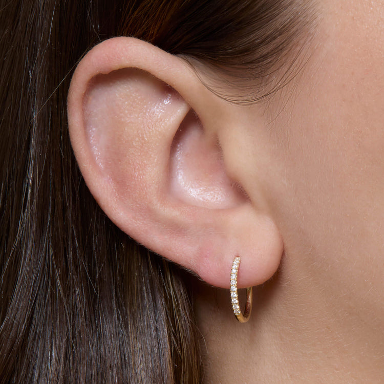 Image of 14K Yellow Gold Classic Pave Huggies on Models Ear