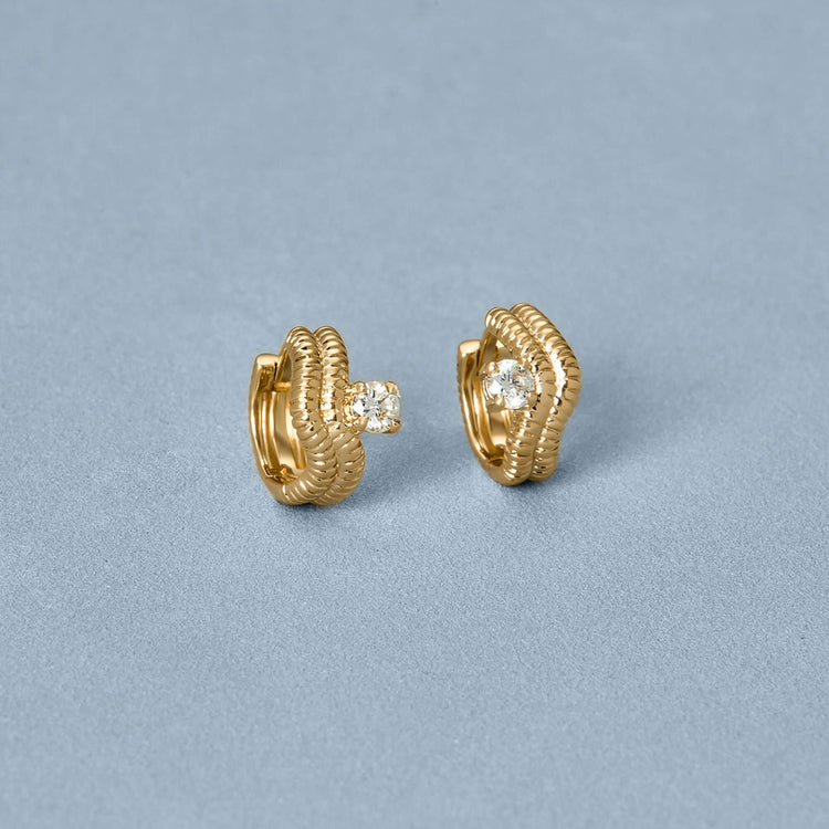 Stone and Strand 14K Yellow Gold Cobra Wave Double Ear Huggies Editorial Image