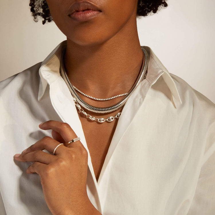 Model wearing Coil Royale Silver Collar with solid gold Stone and Strand jewelry
