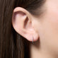 Image of 10K Yellow Gold Come Closer Diamond Mini Huggies on Models Ear