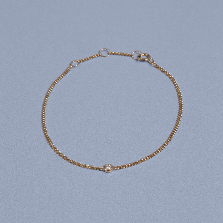 Stone and Strand 14K Yellow Gold Dainty Bezel Solitaire Curb Chain Bracelet Editorial Image