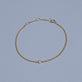 Stone and Strand 14K Yellow Gold Dainty Bezel Solitaire Curb Chain Bracelet Editorial Image
