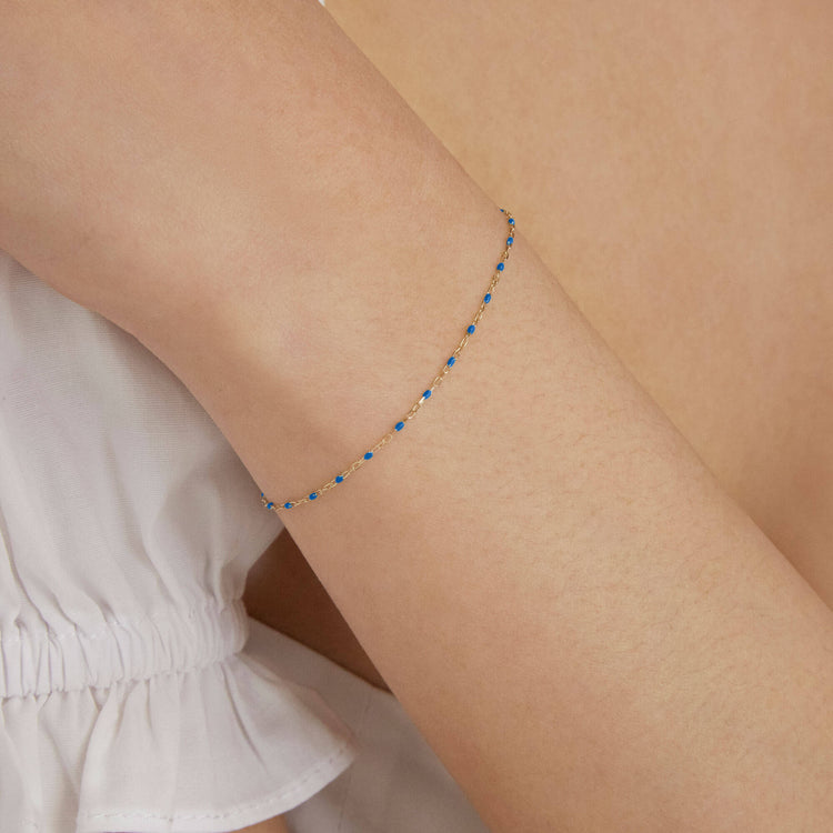 Image of 10K Yellow Gold Blue Dainty Goldie Pop Bracelet on Models Arm