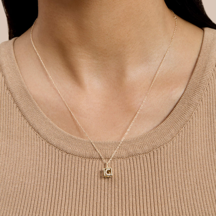 Image of 10K Yellow Gold Diamond Baby Block Necklace on Models Neck