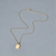 Stone and Strand 14K Yellow Gold Diamond Beekman Dog Tag Necklace Editorial Image