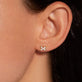 Image of 14K Yellow Gold Diamond Cross Stitch Studs on Models Ear