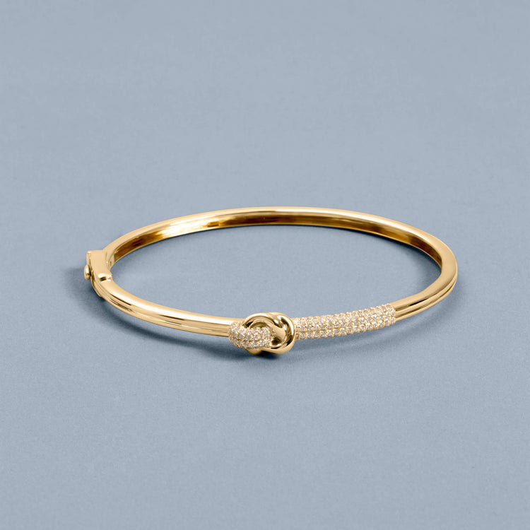 Stone and Strand 14K Yellow Gold Diamond Forme Knot Bangle Editorial Image