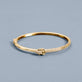 Stone and Strand 14K Yellow Gold Diamond Forme Knot Bangle Editorial Image