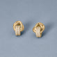 Stone and Strand 14K Yellow Gold Diamond Forme Knot Earrings Editorial Image