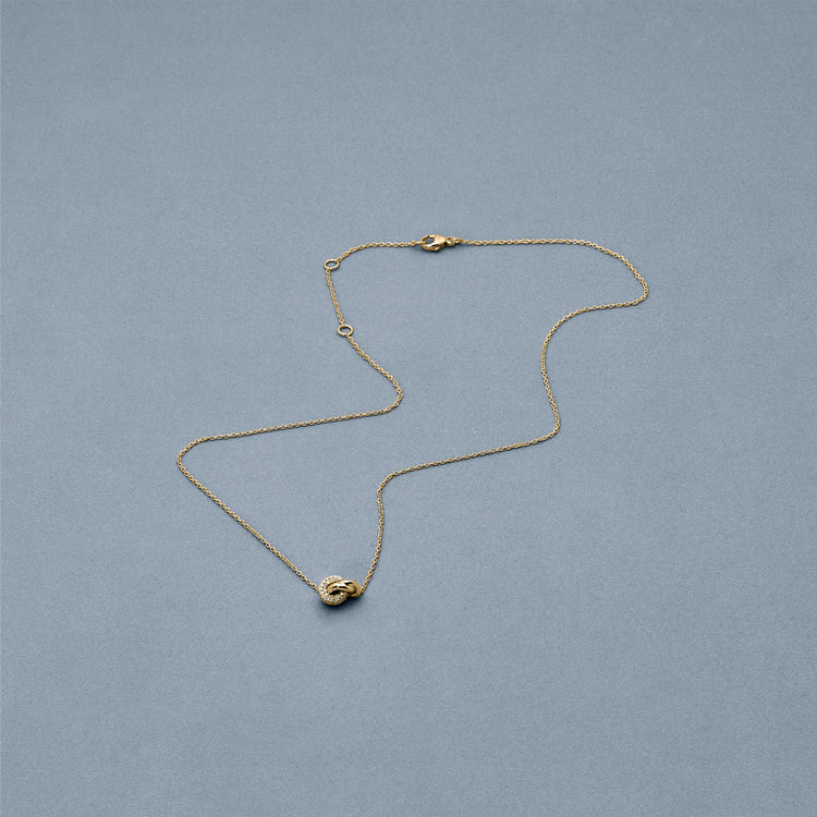 Stone and Strand 14K Yellow Gold Diamond Forme Knot Necklace Editorial Image