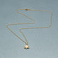 Stone and Strand 10K Yellow Gold Diamond Orbit Mini Medallion Editorial Image