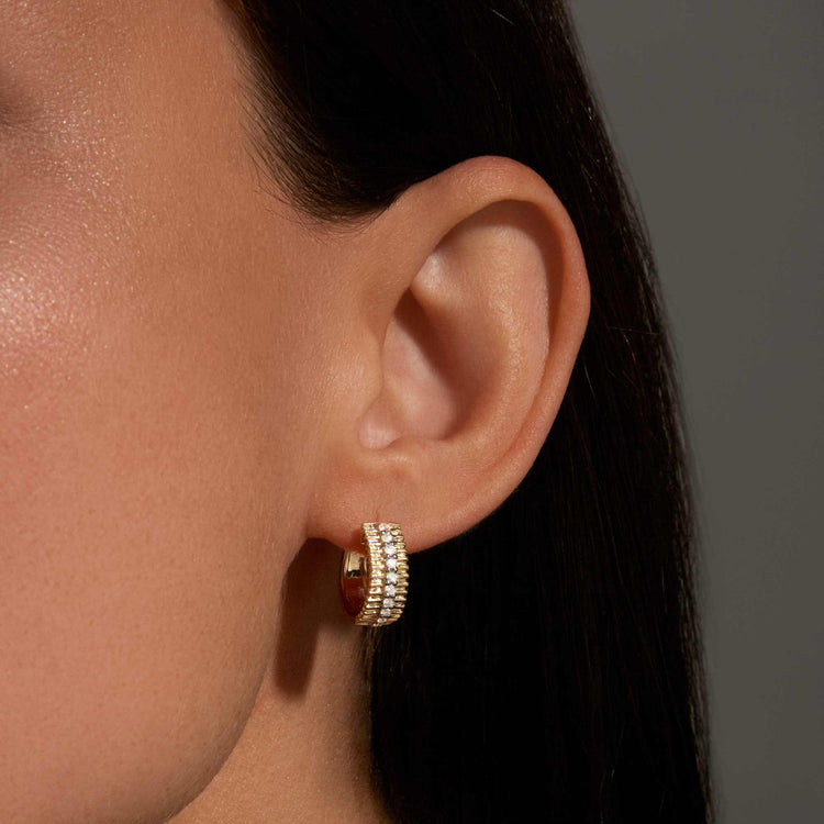 Image of 10K Yellow Gold Diamond Pirouette Huggies on Models Ear