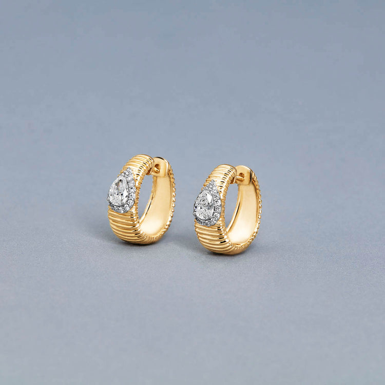 Stone and Strand 14K Yellow Gold Disco Pear Huggies Editorial Image