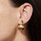 Model wearing Ultra Puff Gold Huggies with solid gold Stone and Strand jewelry