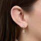 Image of 14K Yellow Gold Emerald Cut LAB-Created Diamond Huggies on Models Ear