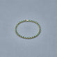 Stone and Strand 14K Yellow Gold Emerald Luxe Bezel Tennis Bracelet Editorial Image