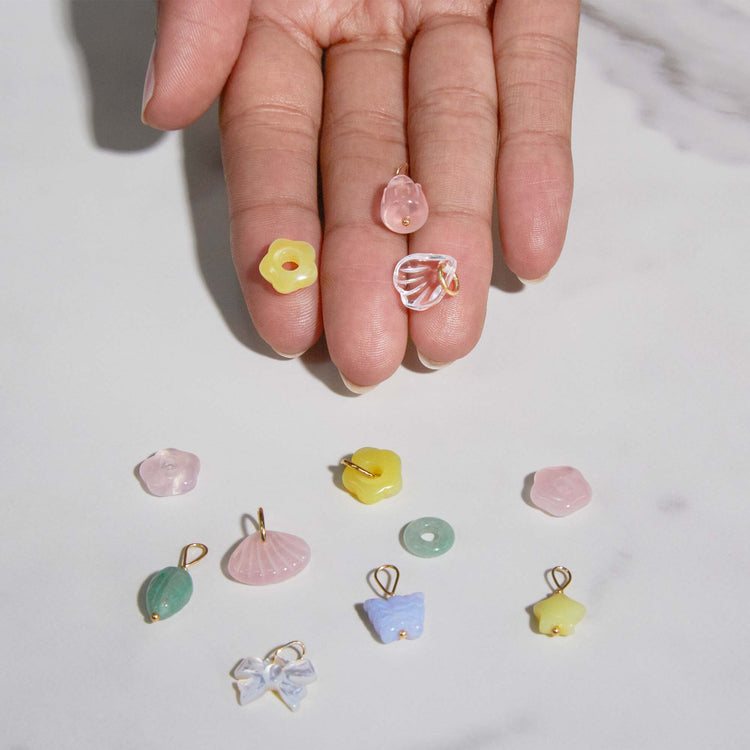 Still life image of Lucky Star Charm with Stone and Strand solid gold jewelry