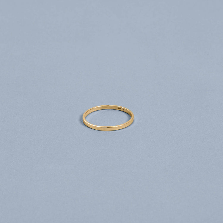 Stone and Strand 14K Yellow Gold Fine Flat Band Editorial Image