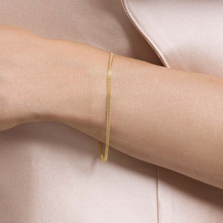 Image of 14K Yellow Gold Flat Arrow Chain Bracelet on Models Arm