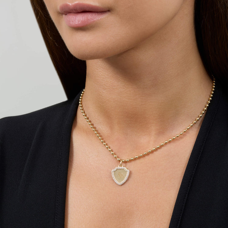 Image of 14K Yellow Gold Founding Member Diamond Crest Charm on Models Neck