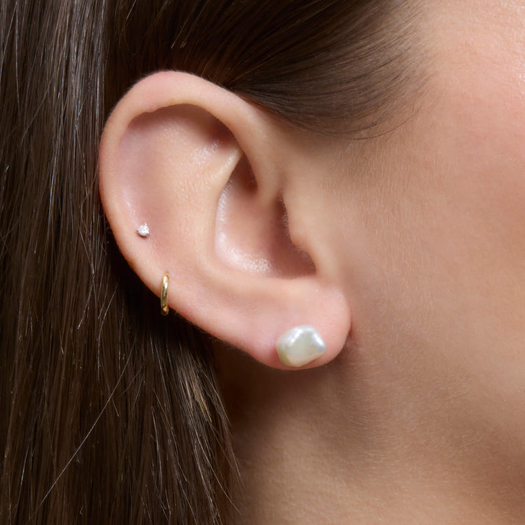 Image of 14K Yellow Gold Freeform Pearl Studs on Models Ear
