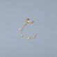 Stone and Strand 10K Yellow Gold Galaxy White Topaz Ear Cuff Editorial Image