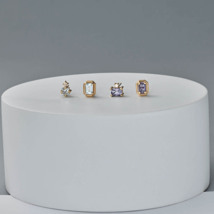 Still life image of Birthstone Emerald Cut Bonbon Studs with Stone and Strand solid gold jewelry