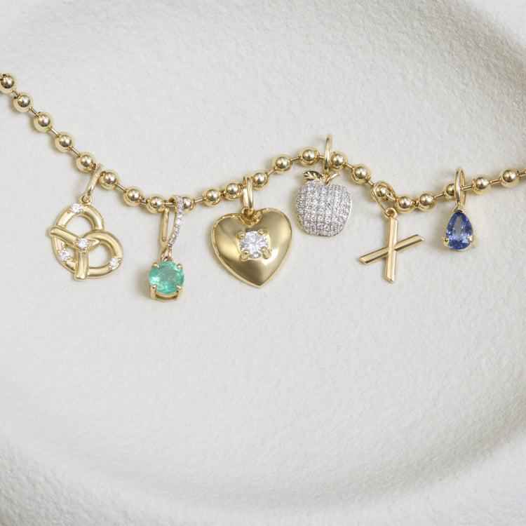 Still life image of Heart And Soul Diamond Charm with Stone and Strand solid gold jewelry