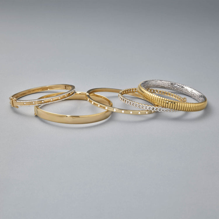 Still life image of Gold Cigar Bangle with Stone and Strand solid gold jewelry
