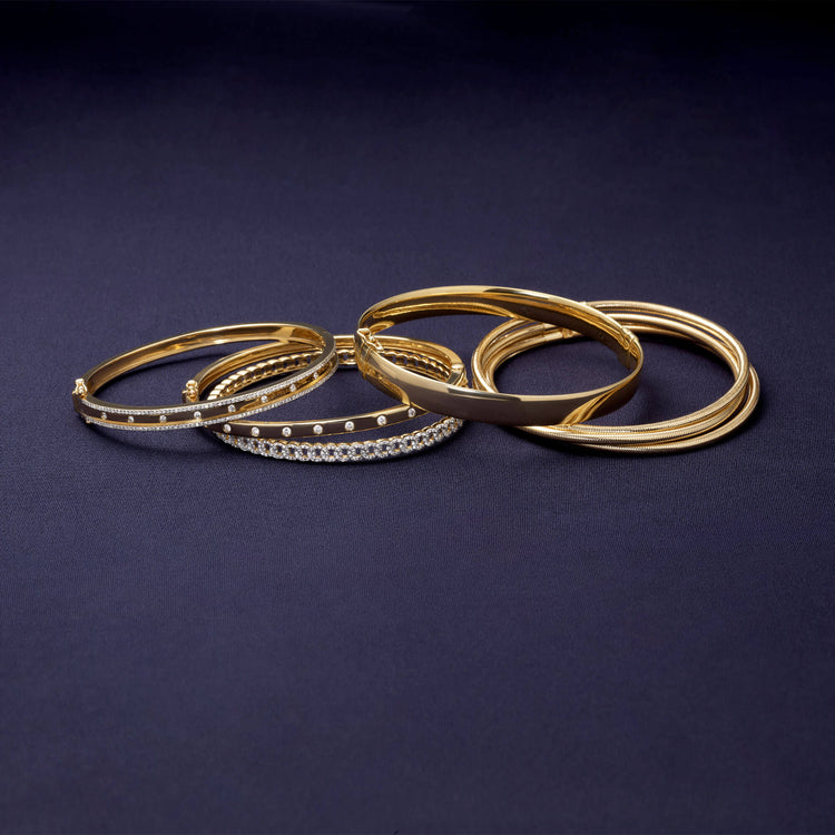 Still life image of Gold Cigar Bangle with Stone and Strand solid gold jewelry