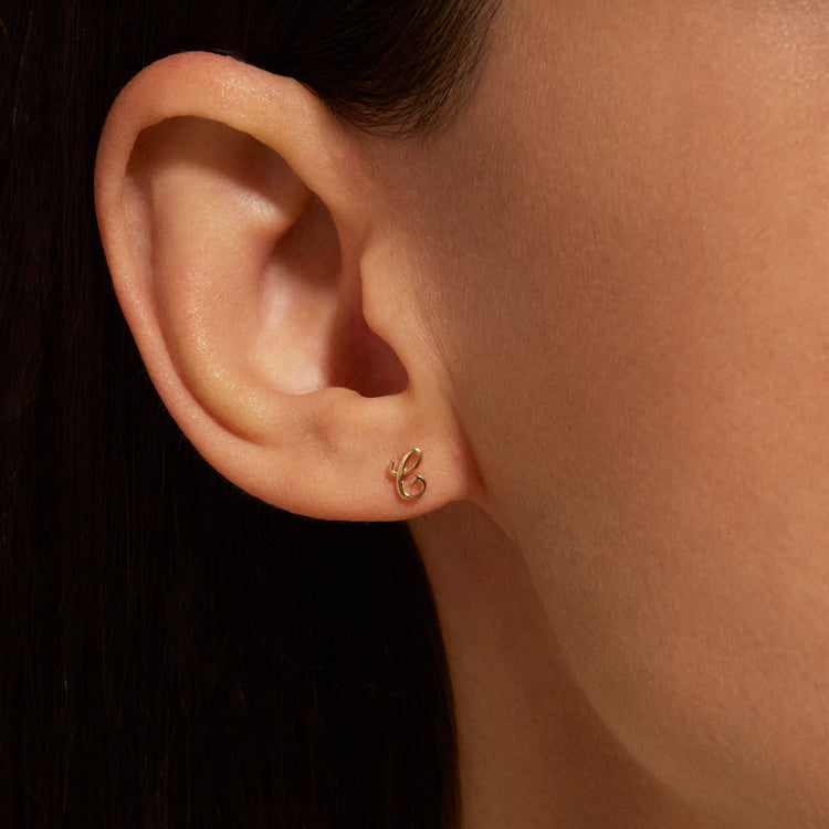 Image of 10K Yellow Gold Gold Cursive Initial Stud on Models Ear